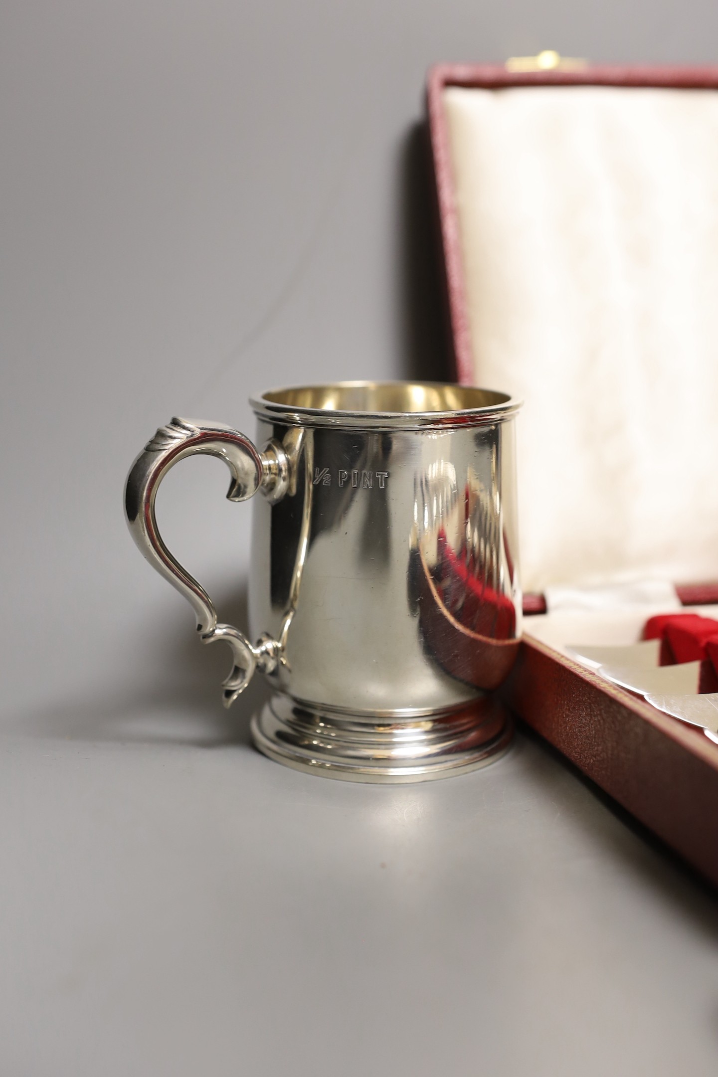 A cased set Garrard pistol handled steak knives, other plated cutlery and a plated mug